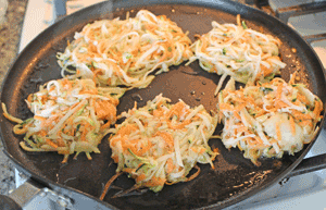 Latkes cooking on non-stick pan