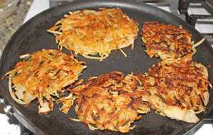 Latkes flipped to cook the other side